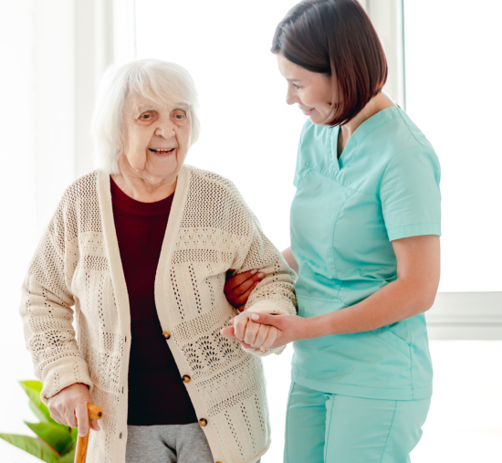 Caregiver and Senior Woman smiling with eachother happily.